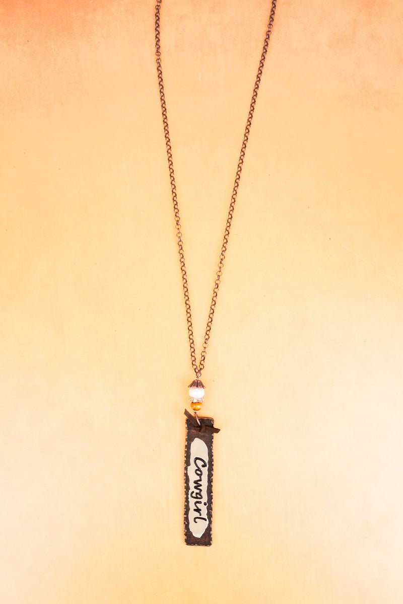 WORN COPPERTONE AND IVORY 'COWGIRL' PENDANT NECKLACE