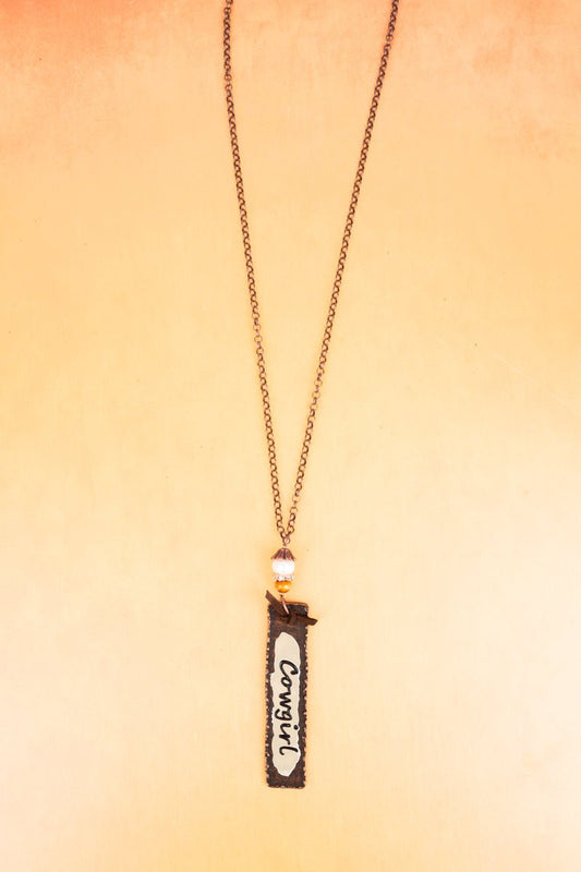 WORN COPPERTONE AND IVORY 'COWGIRL' PENDANT NECKLACE